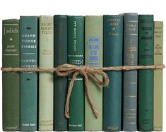 a row of green books tied with rope