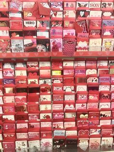 many valentine's day cards are on display in a store