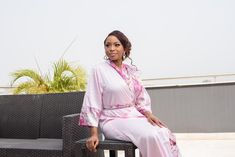 DESIGNER’S NOTE: This elegant pink kimono is crafted from pink lustrous satin paired with a printed floral pink satin that feels so smooth against your skin. We can't think of anything more luxurious to wear while you're getting ready on your wedding day. Designed to flatter your curves. Comfy chic. FIT: Slightly loose for a relaxed fit. Select your normal size ATTRIBUTES: Robe Length: 56 inches Model Stats: 5 ft 6, US 6 wearing a Medium size Color: Pink Fabric: Satin Print: Peacock design Sleev Pink Silk Wedding Robe, Pink Silk Kimono For Wedding, Pink Silk Wedding Kimono, Elegant Pink Bridesmaid Robe, Feminine Wedding Robe With Kimono Sleeves, Pink Robe With Kimono Sleeves For Wedding, Elegant Pink Kimono For Loungewear, Pink Elegant Kimono For Loungewear, Spring Wedding Satin Kimono