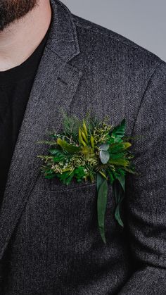 a man in a suit with a boutonniere on his lapel