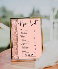 a pink price list on a wooden table