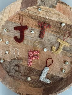 some ornaments are hanging on a wooden board