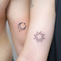 two sun and moon tattoos on both arms, one with a crescent tattoo behind the other