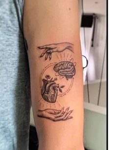 two hands holding a human heart and brain