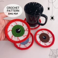 three crocheted coasters sitting next to a coffee cup on a white table