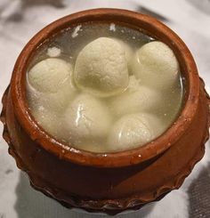 a brown bowl filled with ice cream on top of a table