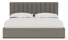 an upholstered bed with two pillows and white linens on the headboard