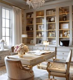 an elegant home office with chandelier, desk and chairs