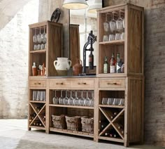 a wooden cabinet filled with wine glasses and bottles