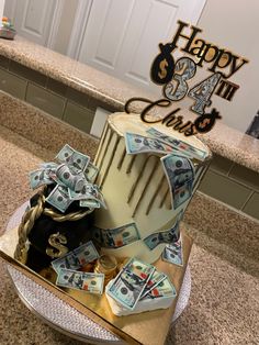 a birthday cake with money on top