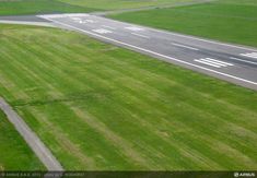 an aerial view of the runway from above, looking down on it's grass and tarmac