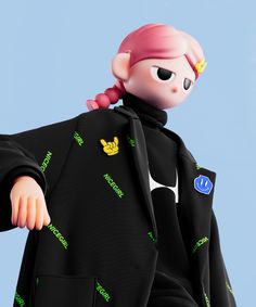 a doll with pink hair wearing a black jacket and green letters on it's chest