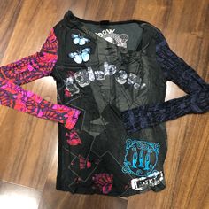 Nwot Desigual Embroidered Long Sleeve T-Shirt. Size Small. Has An Uneven Neck Collar. In Perfect Condition. Bundle To Save. Black Long Sleeve T-shirt With Embroidered Graphics, Grunge Long Sleeve Tops With Graffiti Print, Spring Punk Cotton Tops, Black Y2k T-shirt For Fall, Black Y2k Style T-shirt For Fall, Grunge Graffiti Print Tops For Fall, Black Long Sleeve Tops With Embroidered Graphics, Alternative Long Sleeve Spring T-shirt, Long Sleeve Punk Tops With Graffiti Print