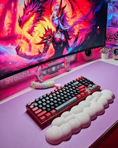 a computer keyboard sitting on top of a desk next to a large monitor and mouse