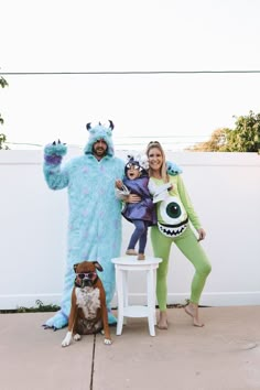 the family is dressed up as monsters and they are posing for a photo with their dog