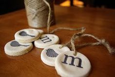 three wooden tags that say i love you and two spools of twine