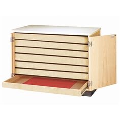 an open drawer with drawers on each side and a red mat in the bottom compartment