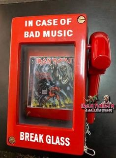 an old red phone with a cover of iron man on it's front and back