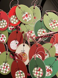 many tags are attached to the handles of each ornament, and have bows on them