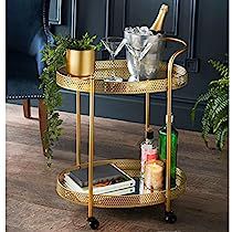 a gold bar cart with bottles and glasses on it