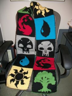 a crocheted blanket sitting on top of an office chair