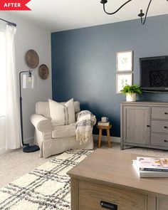 a living room with blue walls and white furniture