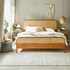 a bedroom with a bed, nightstands and two lamps on either side of the bed