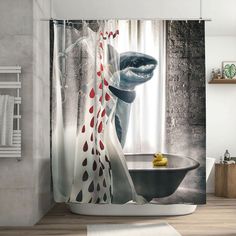 a bathroom with a shower curtain that has a shark in the bathtub