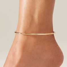 This anklet's innovative flexible steel material makes for an ultra light but statement-making piece. Dane is an oval shape and available in two sizes. The circumference measurement of the anklet is of 9 1/16th” or 10”. Make sure to add an extra ¾ inch minimum to allow for comfort. Dane is easy to put on and remove. To open, gently pull apart the anklet at the seam, rotating the tubes in opposite directions. Close by rotating back to the seam, and inserting the smaller tube into the opening. Fin Bangle Anklet, Anklet Outfit, Ankle Bangle, Ankle Bracelet, Beautiful Anklet, Jenny Bird, Ankle Jewelry, Gold Anklet, Dragon Jewelry