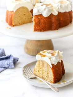 a bundt cake on a plate with a slice cut out and the rest of the bundt cake in the background