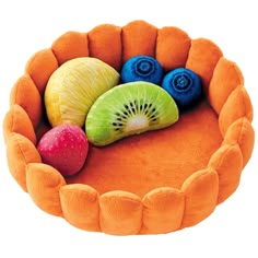 there is a dog bed made to look like a kiwi and other fruit slices