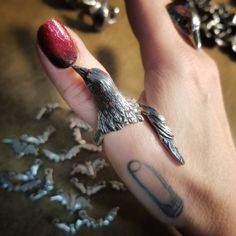 "Handcrafted lead-free pewter adjustable bird wrap ring. This ring is very adjustable but it's best if we set it close to your size. Also, the tail feathers will be slightly trimmed for sizes 8 & below. The pics with the black onyx eyes are an example of the trimmed. 2\" long or less depending on ring size Bird body ¾\" wide All pieces are made-to-order despite the \"in stock\" number in the listing. Time frame varies from piece to piece so please message us if you need something by a certai Hoarding Board, Crow Ring, Raven Ring, Onyx Eyes, Bird Clothing, Bird Ring, Bird Rings, Nail Ring, Tail Feathers