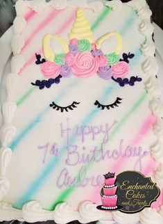 a birthday cake decorated with an unicorn's face