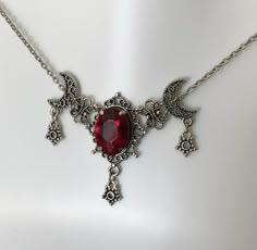 "This is a new handmade necklace. It is made with antiqued silver plated filigrees, accented with a high quality RUBY RED glass rhinestone. Decorated portion is 2 1/2\" wide and 1 3/4\" tall in the center. Necklace is adjustable 15-18\" with a lobster clasp and chain extender. If you would like a different length, please send us a message." Red Goth Accessories, Victorian Goth Necklace, Red Gothic Necklace, Vampy Jewelry, Fantasy Necklace Art, Gothic Aesthetic Victorian, Fantasy Jewelry Necklace, Black And Red Necklace, Red And Black Necklace