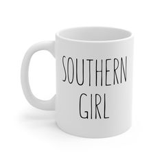 a white coffee mug with the words southern girl printed on it and black letters across the bottom