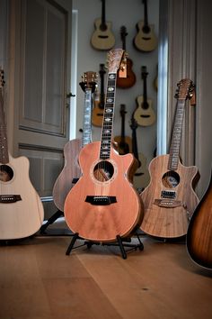 guitars are lined up in a row on the floor