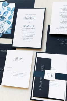 the wedding stationery is laid out on top of each other