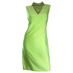 Chic vintage 1960s lime green shift dress! Flattering shilouette, with amazing details! Features hand-sewn iridescent sequins and beads at bust, with pearls lining the collar. Jackie O style that exudes class and fashion! Designer labels are missing, but most certainly produced by a high-end designer by the amazing construction. Full metal zipper up the back with hook-and-eye closure. No fabric label, but feels like a possible silk and cotton blend. In great condition. Approximately Size Medium 1stdibs Fashion, Suit Tattoo, Bright Green Dress, Mod Shift Dress, Green Chiffon Dress, Vintage Green Dress, Green Sequin Dress, Informal Dress, Lime Green Dress