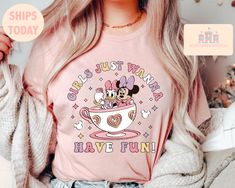 a woman with long blonde hair wearing a pink shirt that says girls just want have fun