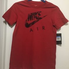 Athletic Cut Crew Neck T-Shirt, Ribbed Neck Band. Nike Air Graphics On The Chest. Color Varsity Red, 100% Cotton, Machine Washable. Nike Red Graphic Tee, Nike Red Graphic Tee Top, Nike Red Tops For Streetwear, Red Nike Tops For Streetwear, Nike Tee, Nike Tees, Nike Shirts, Kids Shirts, Neck T Shirt