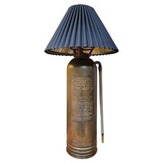 an old fashioned fire extinguisher lamp with a blue shade