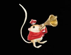 a toy mouse with a trumpet in it's mouth