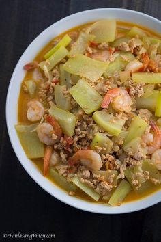 a white bowl filled with food on top of a table