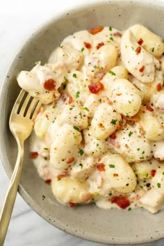 a white bowl filled with pasta covered in sauce