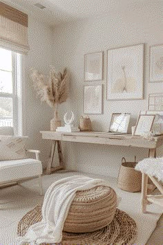 a living room with white furniture and pictures on the wall, rugs in front of a window