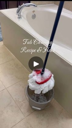 a mop is sitting on the floor in front of a bathtub with text that reads tub cleaning recipe & hack