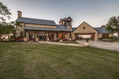 a large house sitting on top of a lush green field