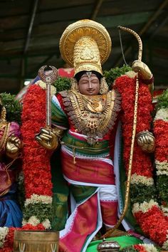 an idol is displayed in front of some flowers