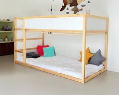 a child's bedroom with a bunk bed and wall stickers on the walls