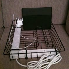 a wire basket with wires connected to an electronic device